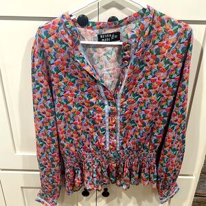 Nrvna Mode flower print button up blouse with elastic peplum.